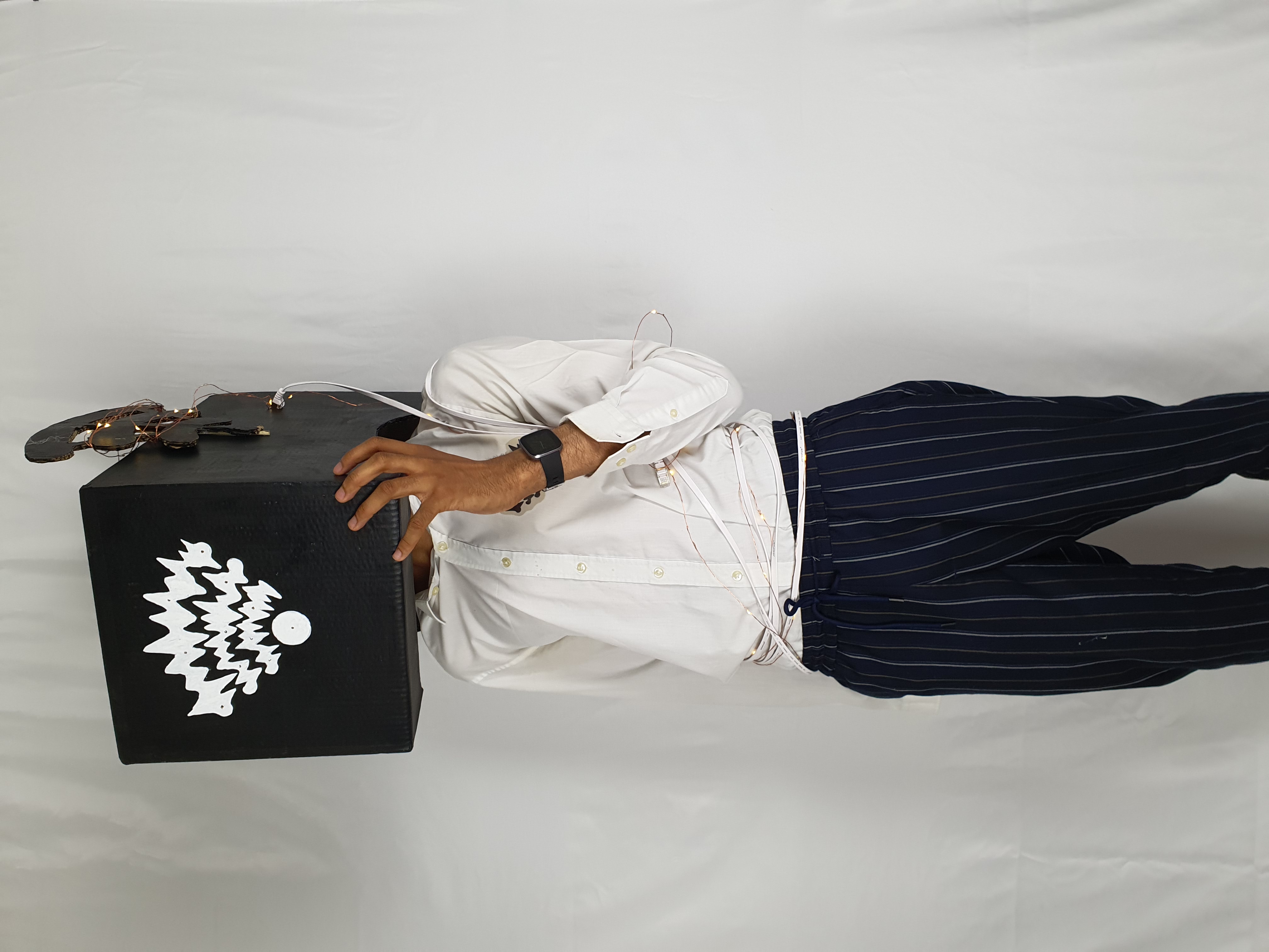 an image of a man posing with a rectangular box on his head with a scribbly wifi symbol.